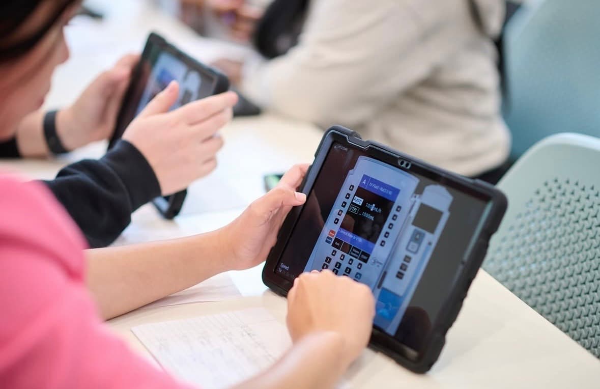 Nursing students using SimVS-IV tablets in classroom setting